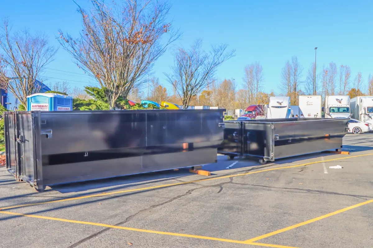 Professional dumpster rental service with roll-off container on residential driveway in Norcross